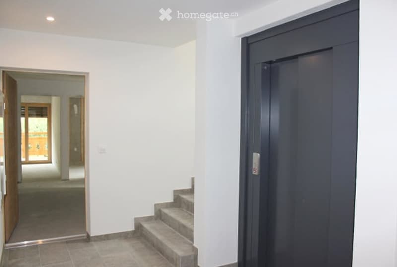 elevator, stairs, white walls, gray floor