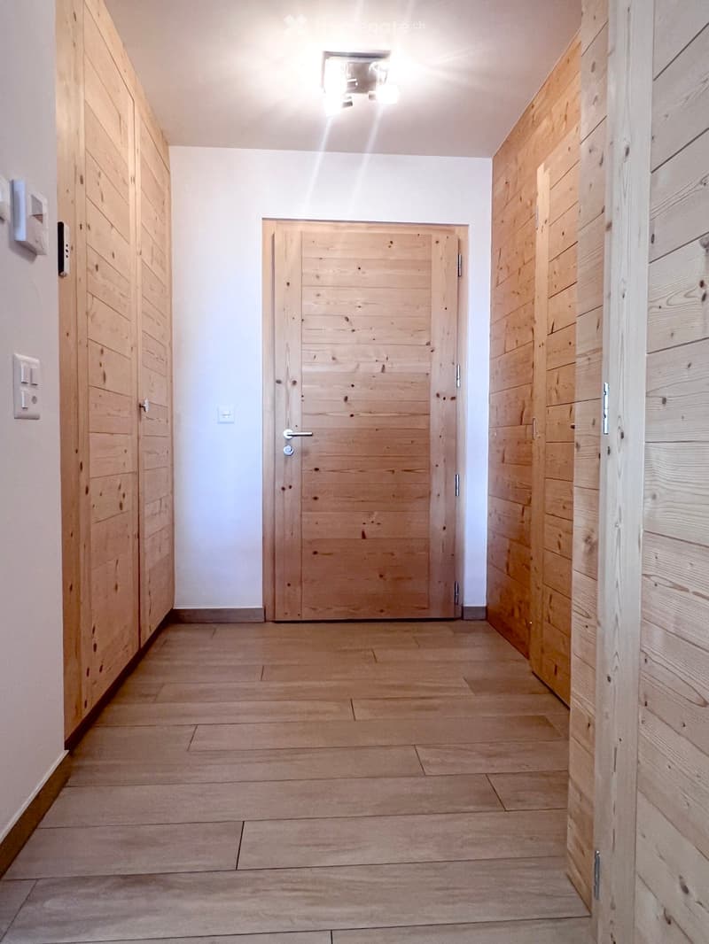 wooden walls, wooden floor, wooden doors, white walls, ceiling light