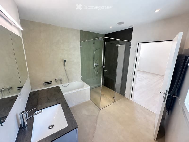 modern bathroom with bathtub, shower, sink, mirror, and open door
