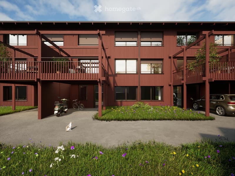 3 story building, red wooden exterior, multiple balconies, garage, bicycles parked
