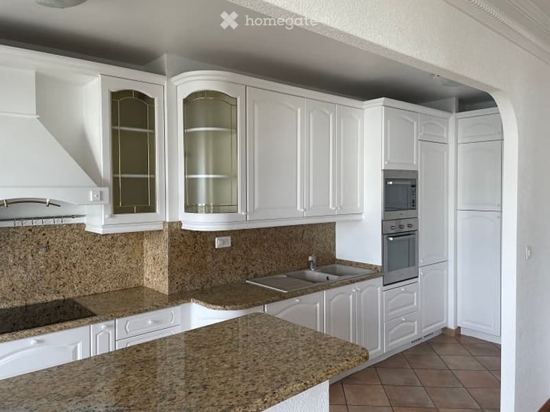 modern kitchen with white cabinets, granite countertops, built-in oven and microwave, double sink, and granite backsplash