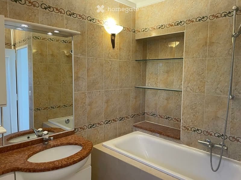 Bathroom with bathtub, sink, mirror, shelves, and shower