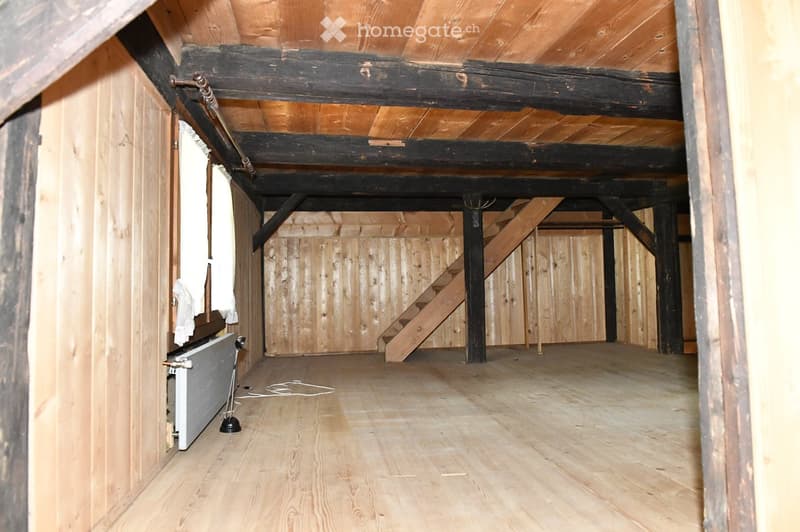 empty room, wooden walls, wooden floor, wooden beams, wooden stairs, radiator