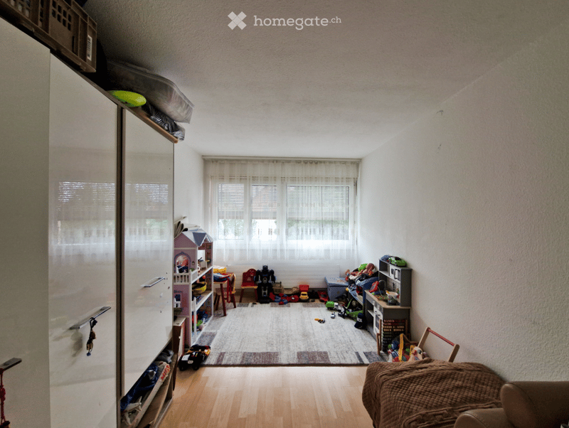 empty room, white walls, floor covered with carpet, two white wardrobes on the left side, white window with curtains