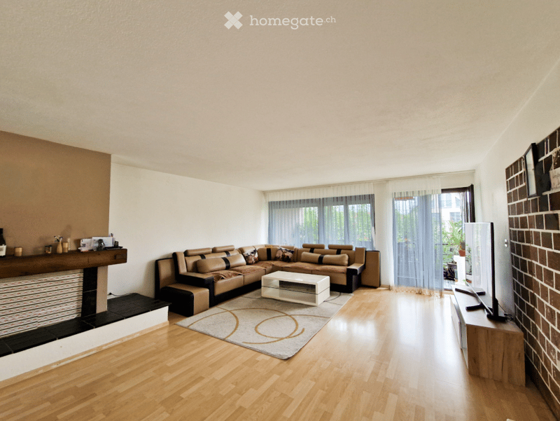 modern fireplace, L-shaped sofa, center table, TV, wooden flooring, curtained window