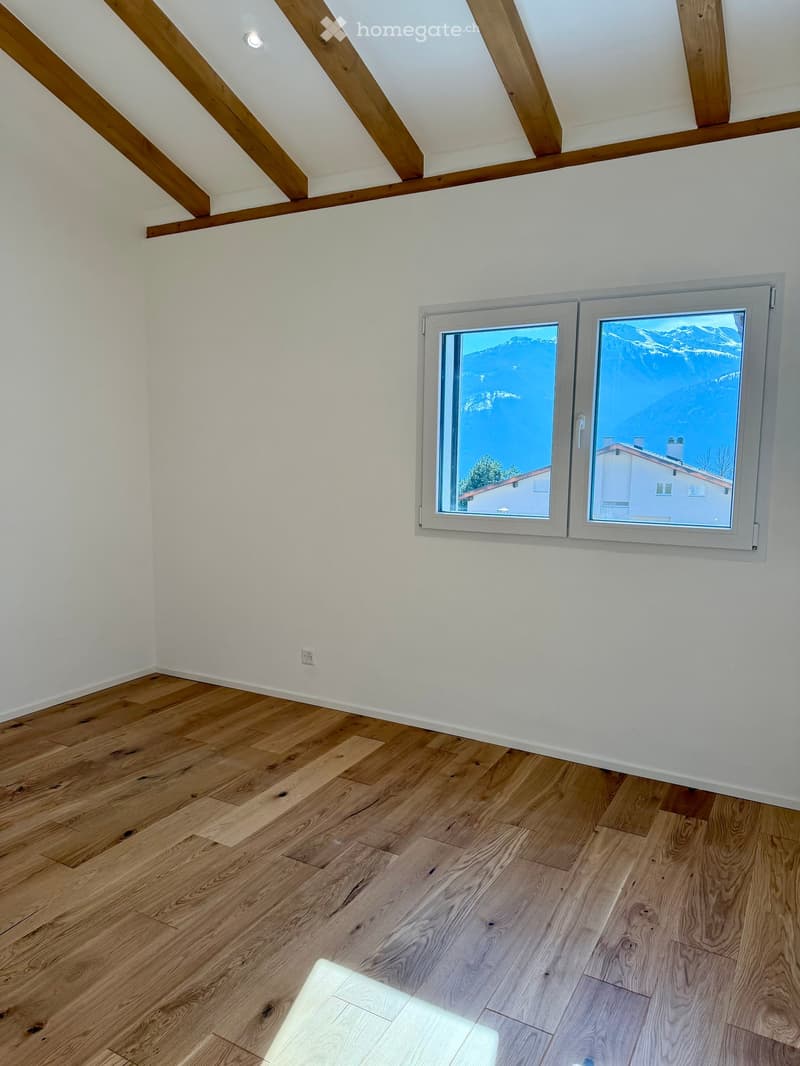 empty room, wooden floor, white walls, large window with mountain view