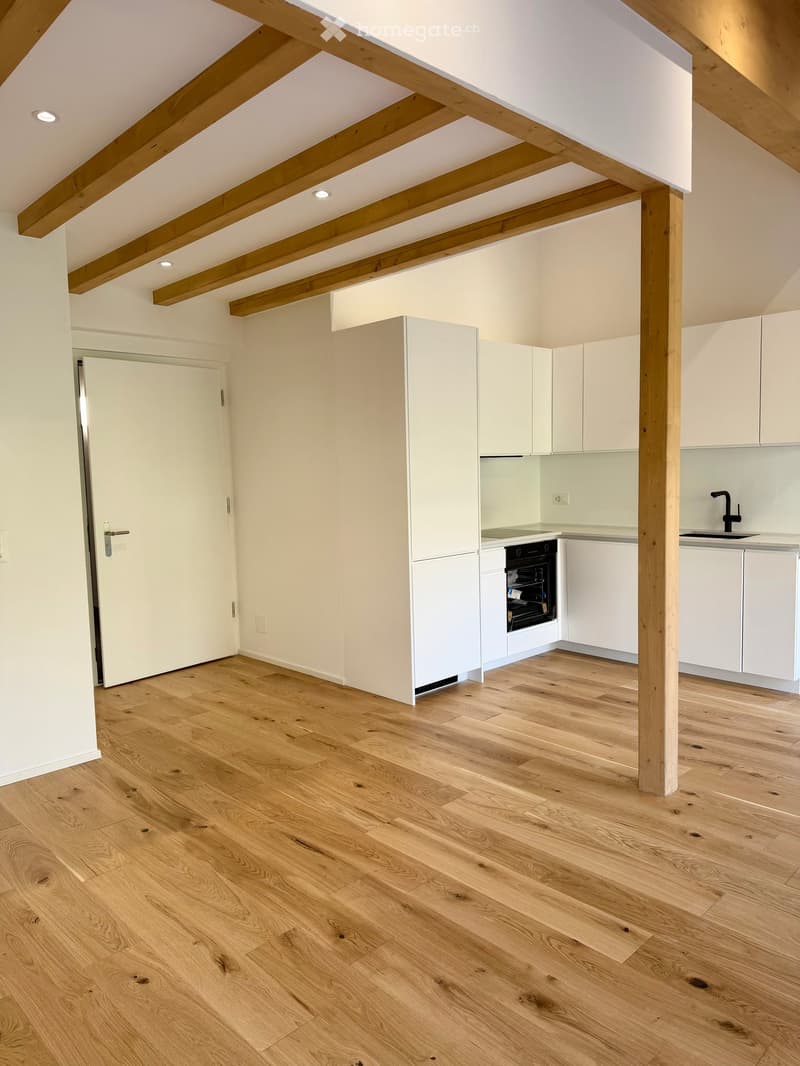 modern kitchen with wooden beams, white cabinets, wooden floor, open door, sink, oven