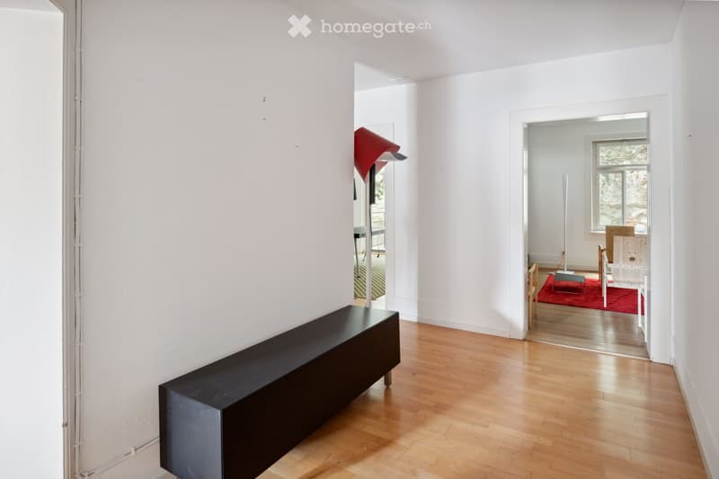 modern empty room, white walls, hardwood floor, black bench, glass doors leading to another room, floor lamp, minimalistic decor