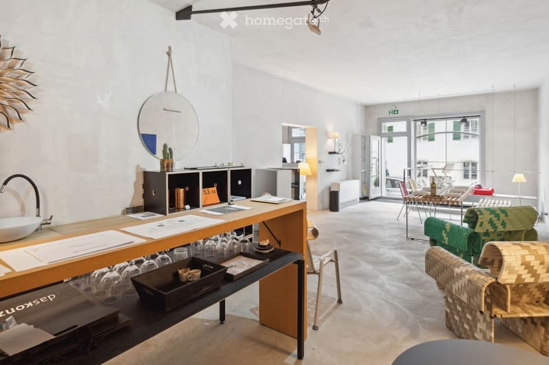 modern minimalistic room, tables with wine glasses and bowls, a wall with a round mirror, a mounted cactus in pot, white and grey interior, large windows with balcony view