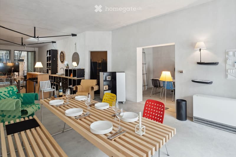 modern open living space with dining table, chairs, benches, kitchen area, various lamps and lighting, and furniture.