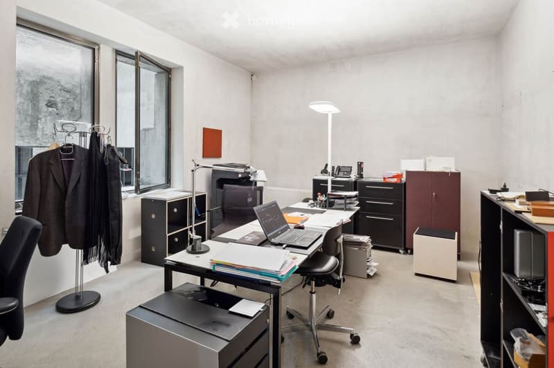 modern office space with a desk, chair, shelves, cabinets, laptop, printer, lamps