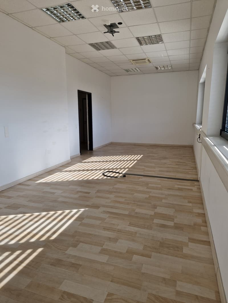 empty room, wooden floor, white walls, ceiling with lights and air conditioning, door, window