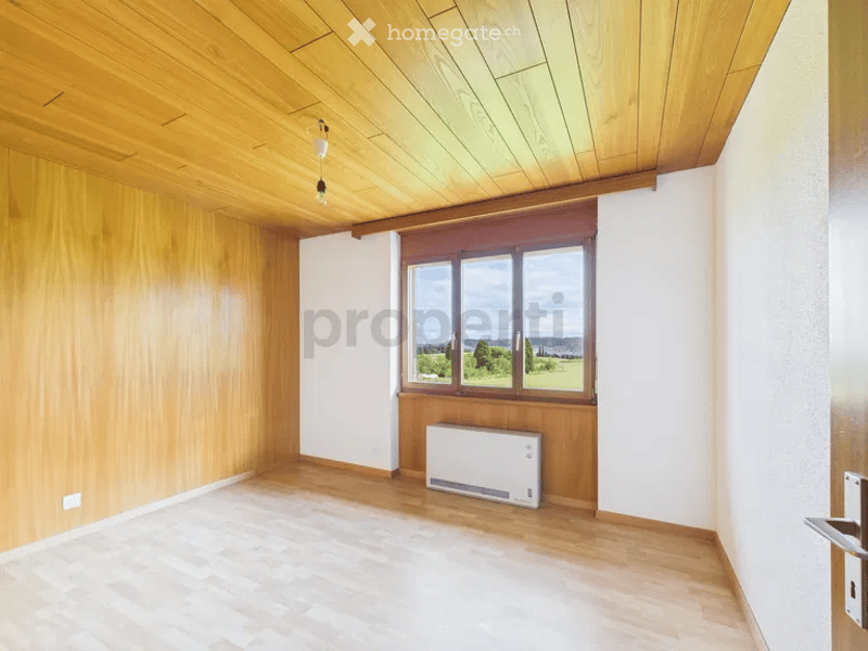 empty room, wooden walls, wooden floor, large window, heater