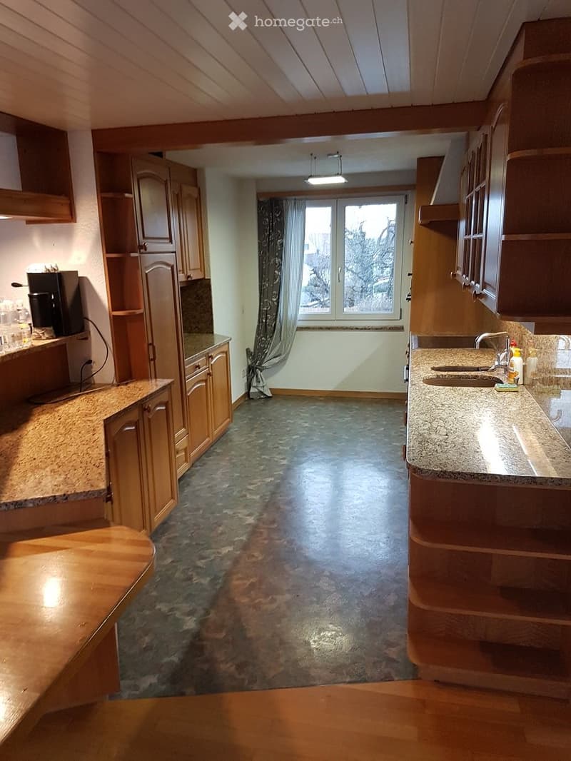 kitchen with wooden cabinets, granite countertops, sink, faucet, window with curtains, ceiling lamp