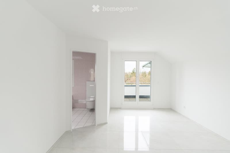Empty room with white walls, white tiles, balcony with glass doors, toilet
