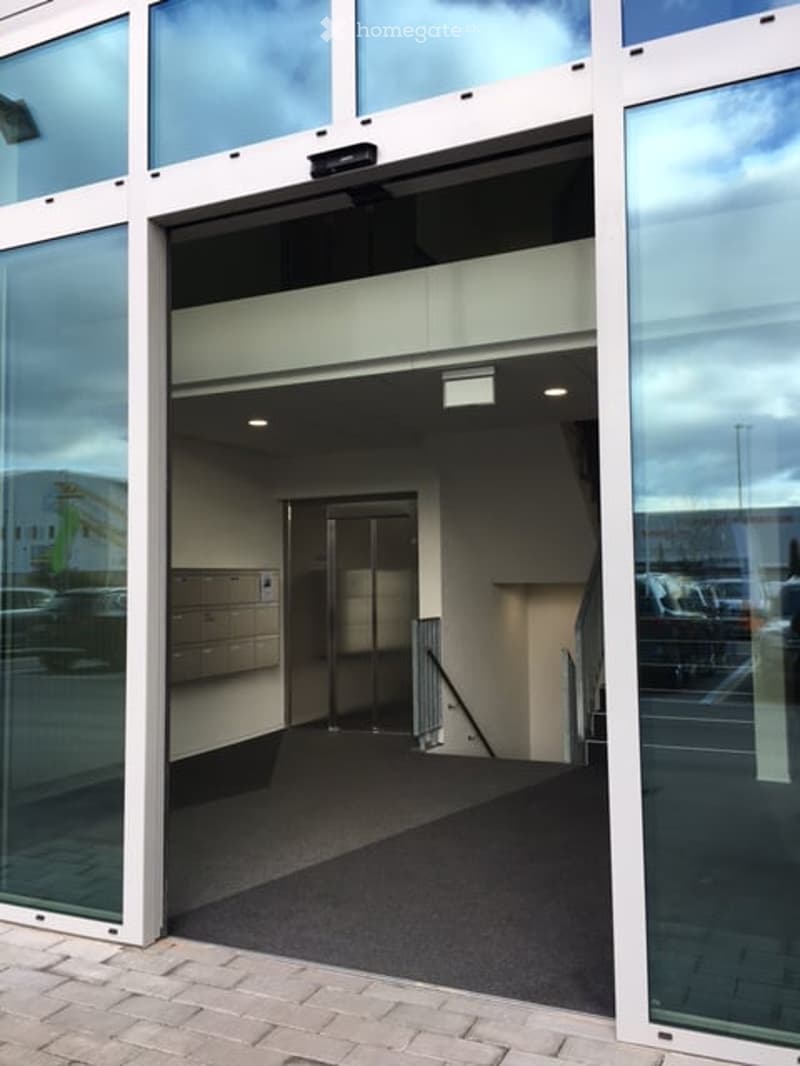 Glass doors, glass walls, elevator, carpeted floor, mailboxes, staircase