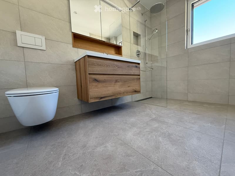 modern bathroom with white toilet, wooden vanity, glass shower enclosure, and tiled floor