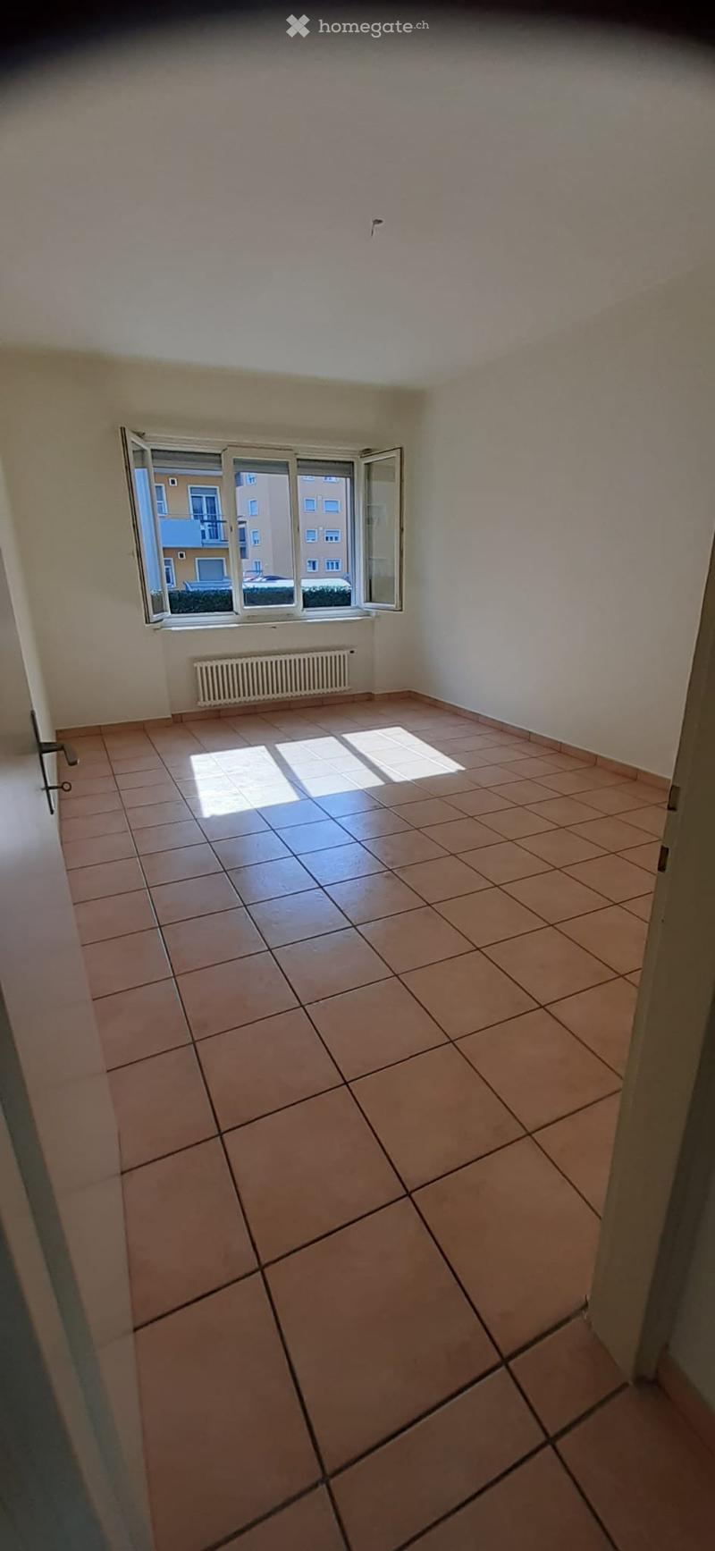 empty room, tiled floor, large window, white walls, radiator