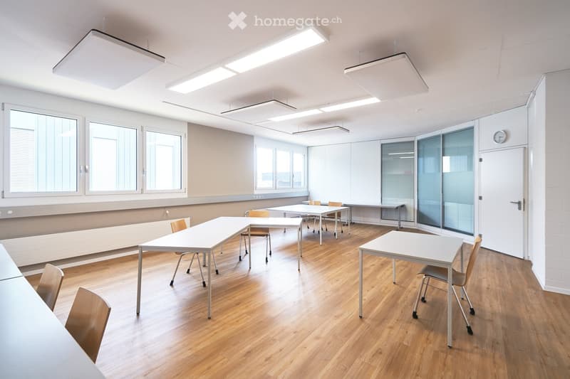 empty room, white walls, wooden floor, white tables and chairs, windows, ceiling lights