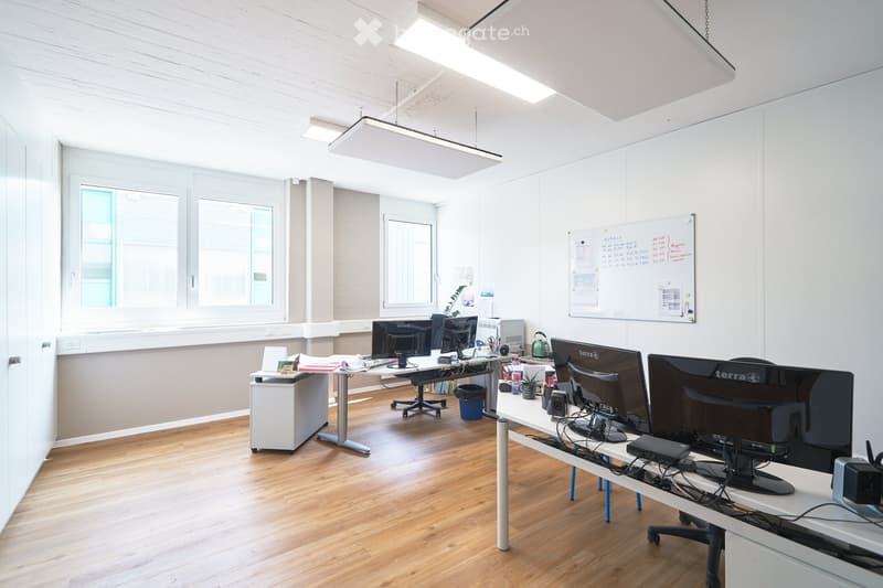 modern office, white walls, wooden floor, desks, monitors, whiteboard, windows
