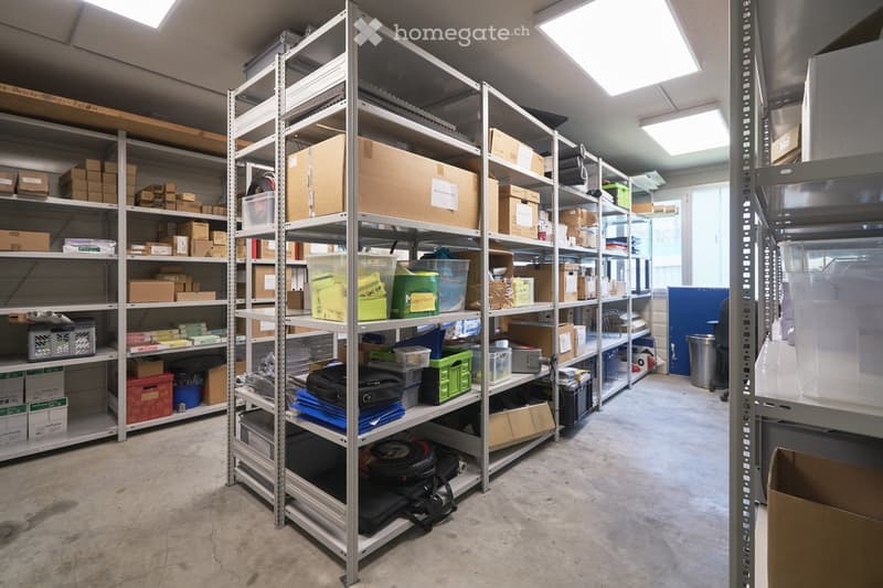 Storage room with metal shelves, boxes, plastic containers, and other storage items