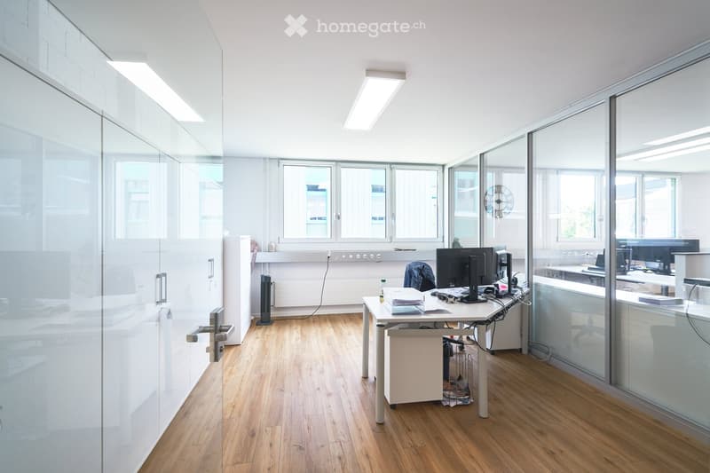 modern office, white walls, glass partitions, wooden floor, desk, computer, monitor, office chair, radiator, windows