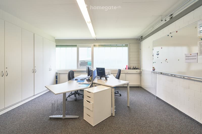 empty office room with desks, chairs, cabinets, whiteboard, carpeted floor