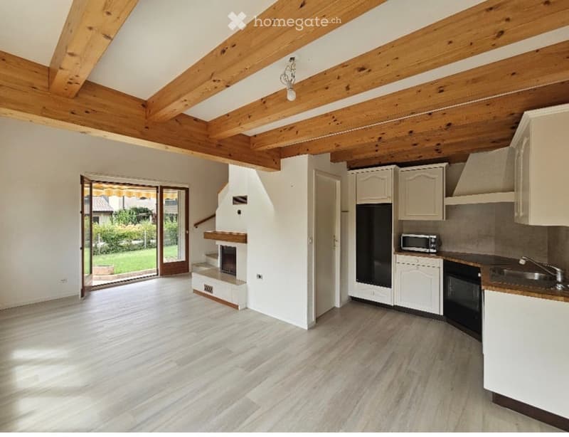 open plan kitchen and living room, wooden beams, fireplace, sliding glass door, hardwood floors