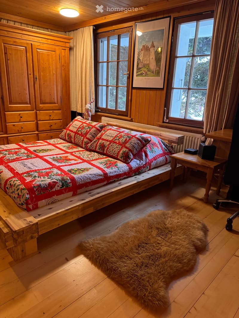 wooden bed, wooden floor, wooden cabinet, radiator, window, fur rug, nightstand, tissue box