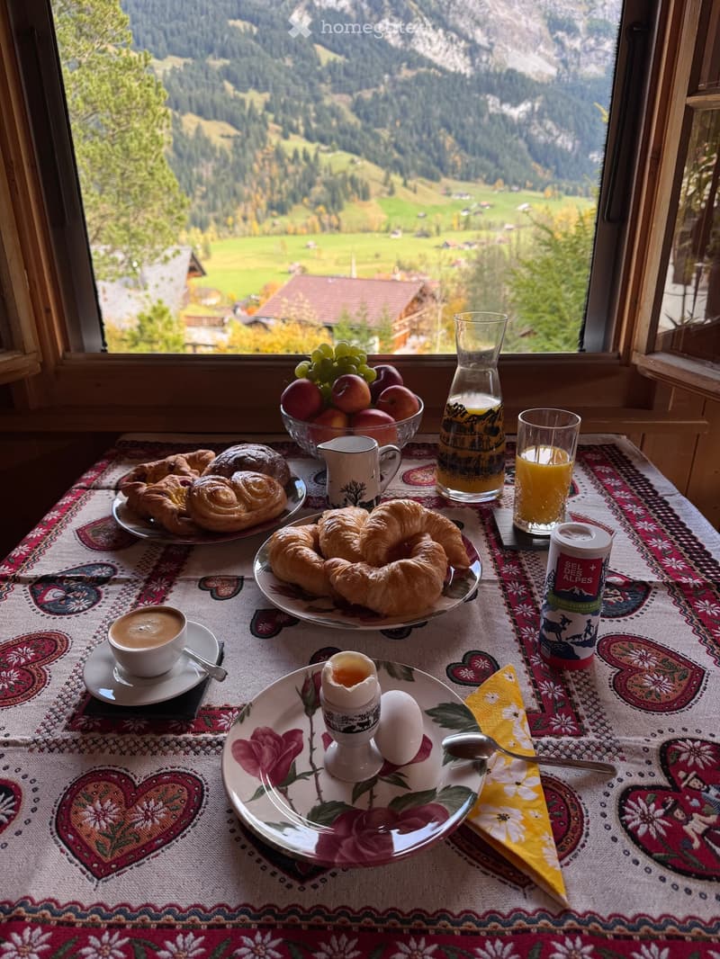 Dining table with breakfast spread, view of mountains