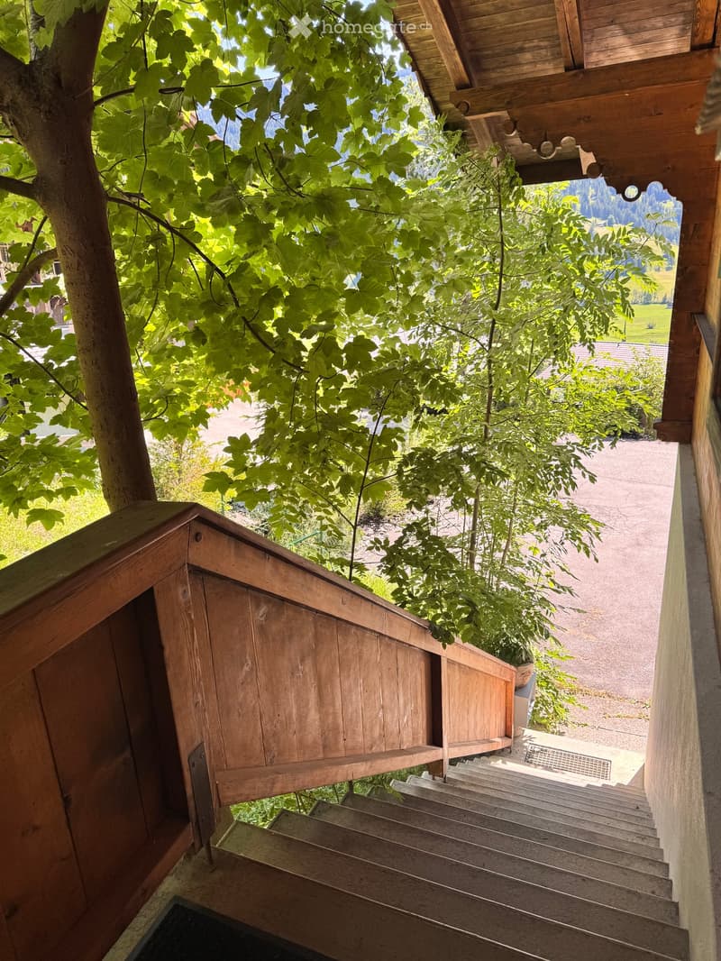 wooden stairs, wooden railing, green trees, view of the mountains