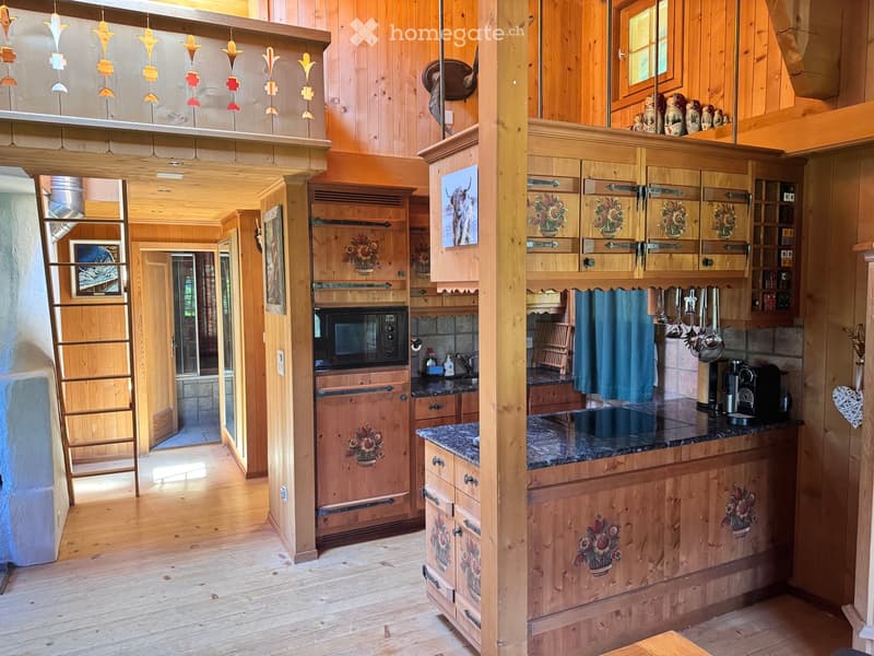 kitchen with wooden cabinets, granite countertop, microwave, sink, coffee machine, ladder