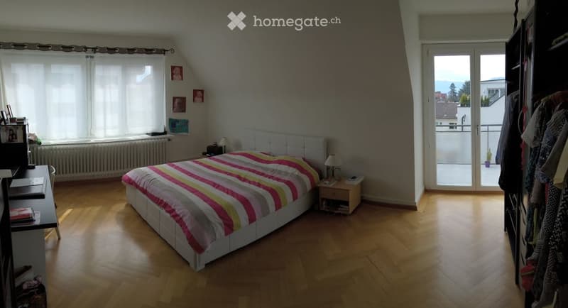 bedroom with bed, desk, lamp, radiator, sliding glass door to balcony