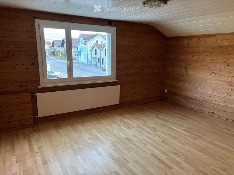 empty room, wooden walls, wooden floor, large window, white radiator