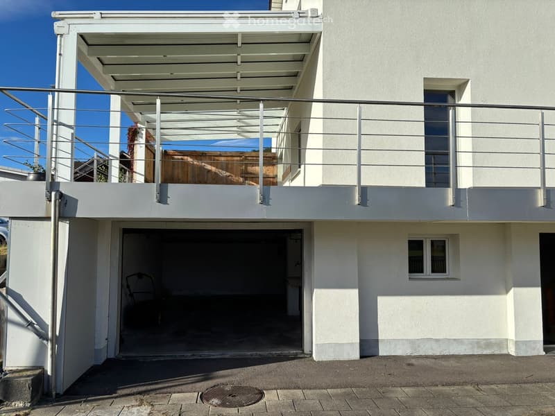 modern white house, garage, balcony with metal railings