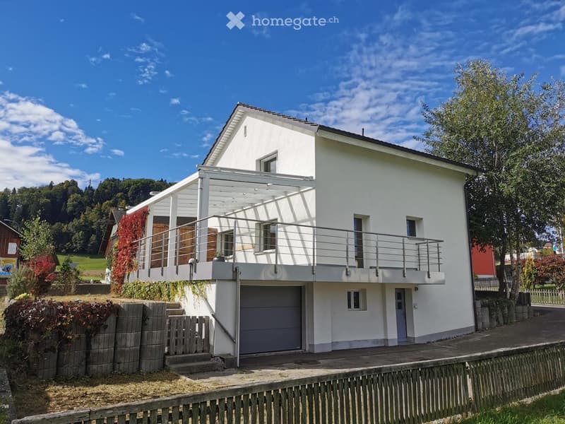 2 story house, white exterior, garage, balcony, garden