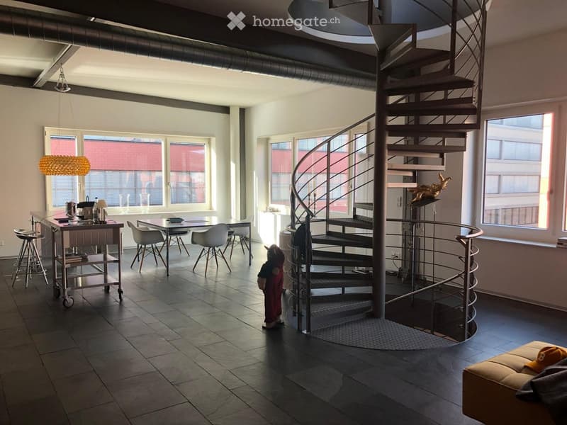 large open space, spiral staircase, dining table, kitchen island, large windows