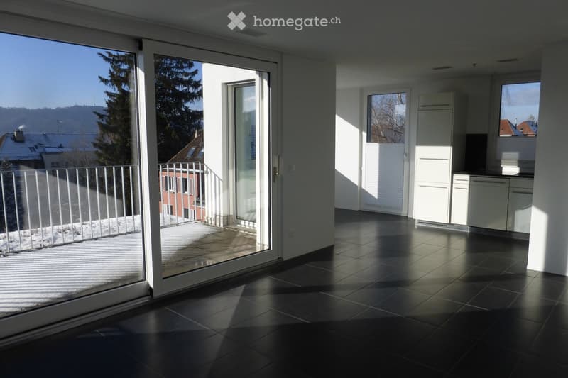 modern design, large windows, sliding glass doors to balcony, white ceiling and walls, black tiled floor