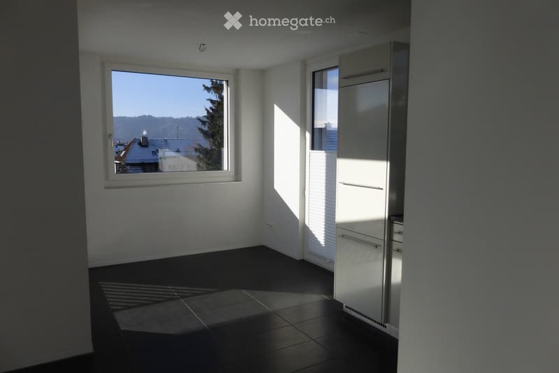 Empty room with floor tiles, two large windows, white walls, window blinds, large mirror in one of the walls.