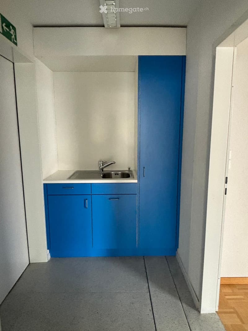small kitchen area with sink, cabinets, and a dishwasher