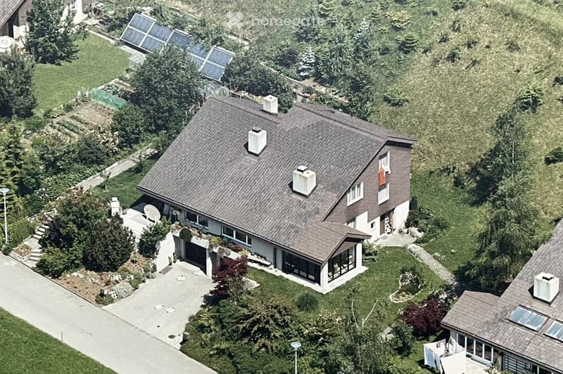 Detached house, brown roof, white walls, solar panels, driveway, garden, trees, plants