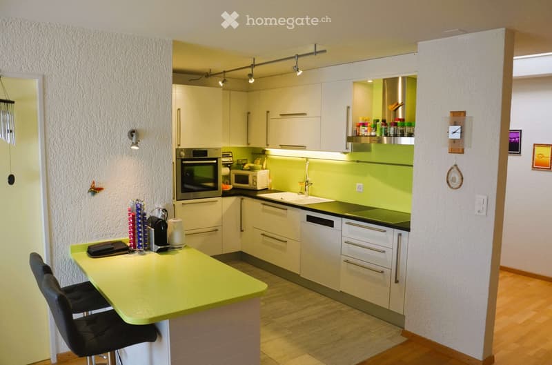 modern kitchen with white cabinets, green countertops, stainless steel appliances, and a yellow countertop