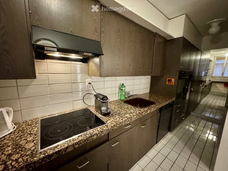 kitchen with granite countertop, electric stove, sink, faucet, bottle, coffee machine, cabinets, power outlet, ceiling lamp