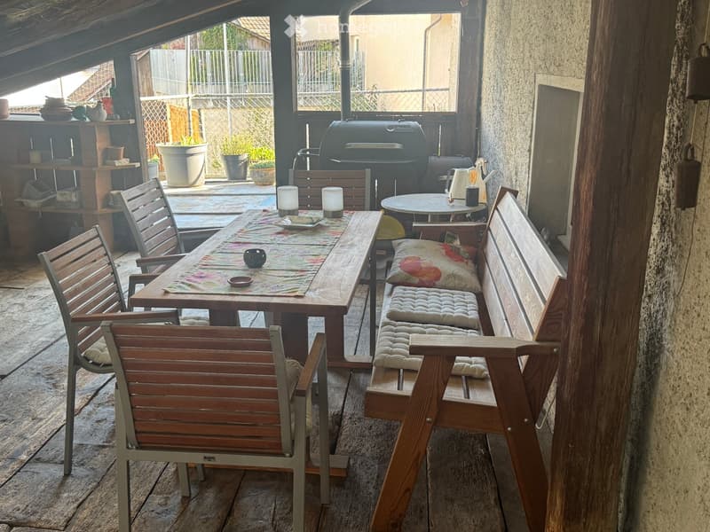 wooden table, wooden chairs, wooden bench, cushions, candles, grill, shelves, potted plants