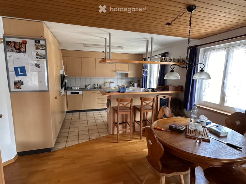 kitchen with dining area, wooden cabinets, tiled floor, wooden table, chairs, counter with stools, window, refrigerator, sink, faucet, kitchen appliances