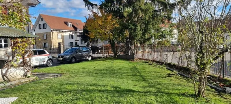 Frontyard, grass, paved area, 2 cars parked