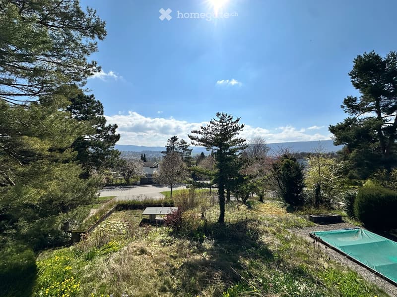 A garden with a table tennis table, a covered pool, and a view of the mountains
