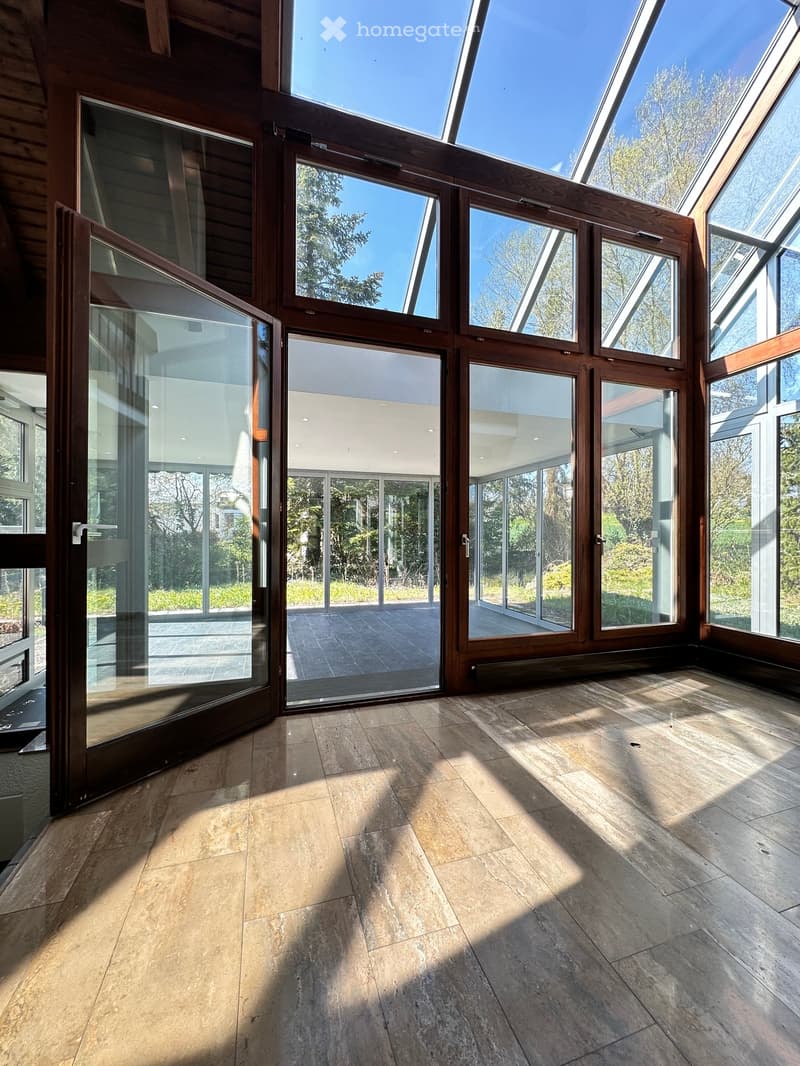 large glass doors, wooden floor, glass ceiling, view of outside