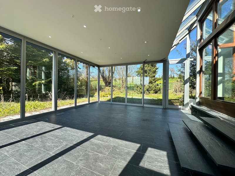 large glass windows, tiled floor, open to outdoor garden