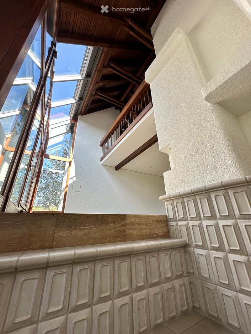 room with wooden ceiling, glass windows, balcony, white walls, tiled floor